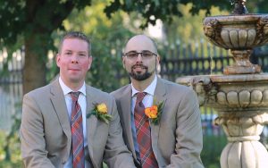 two men sitting together on wedding day.