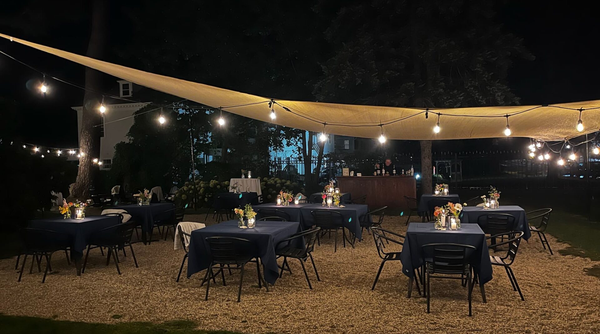 Outside dining under tent with lights